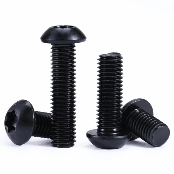 Four Torx button head screws with ribbed heads stand upright, leaning against each other on a white background.