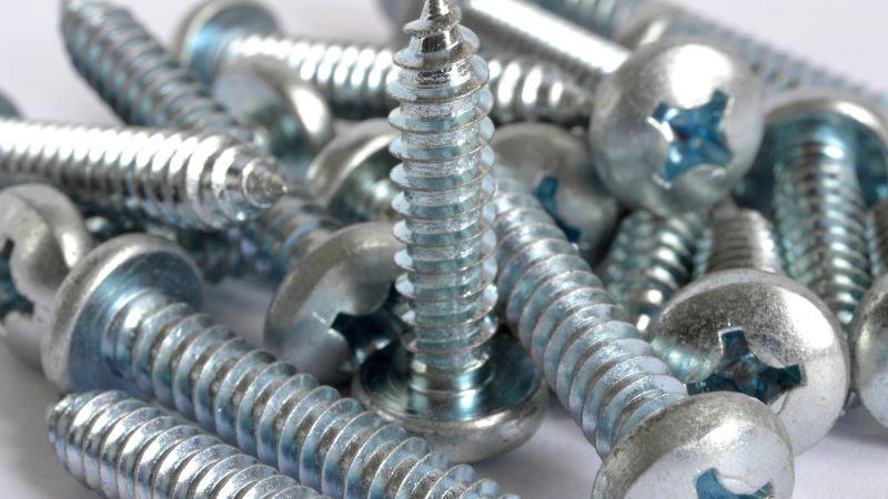 A close-up of silver Phillips head screws, highlighting their fine threads for precise fastening.