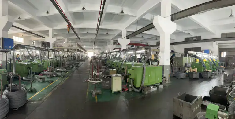 Modern manufacturing facility with green machinery and equipment in an industrial setting, showcasing the production area of Oukailuo.