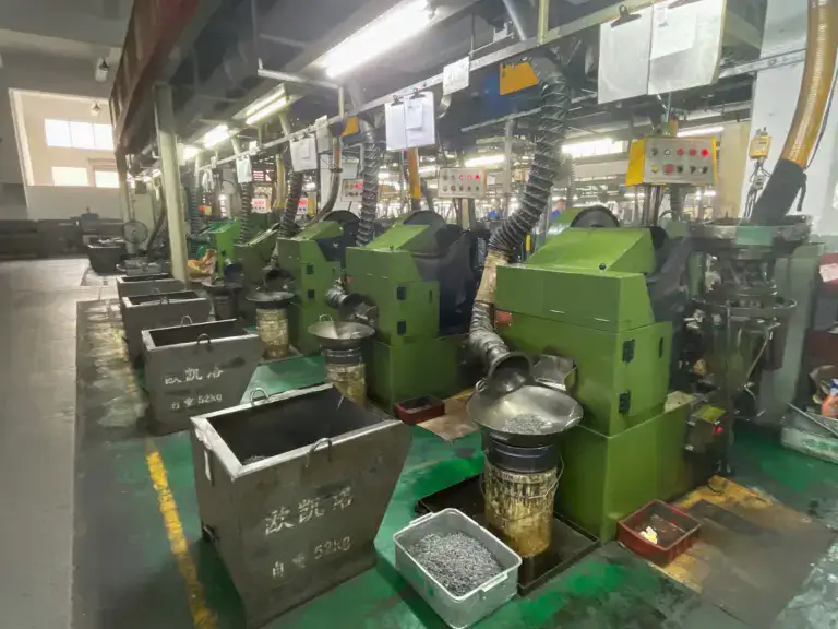 Industrial manufacturing machinery at Oukailuo, showcasing green automated equipment used for precision production processes.